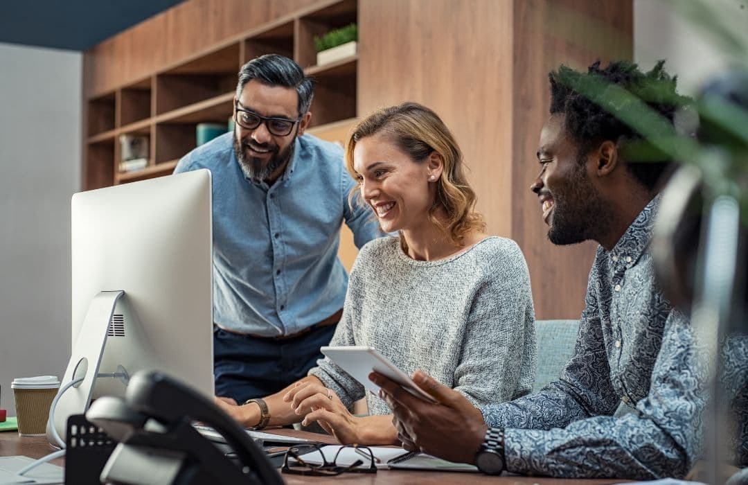 Professionals in a modern office looking at a screen
